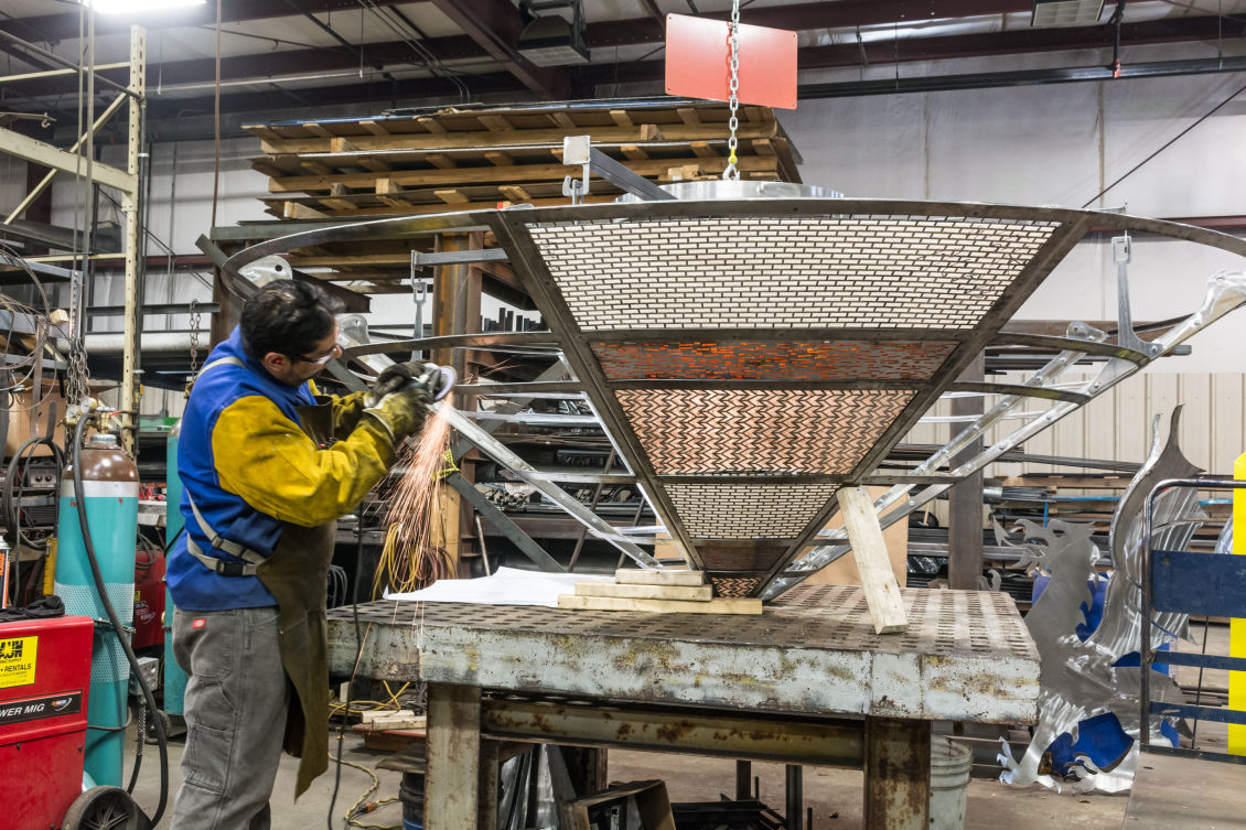 Worker Grinding Metal